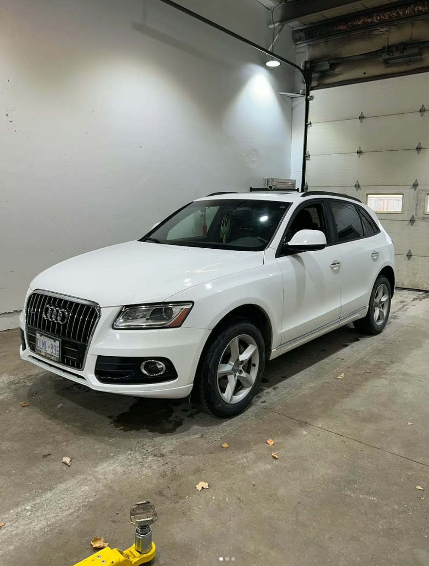 White Audi Q5 parked inside the shop